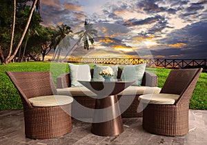 Rattan chairs in outdoor terrace living room against beautiful s