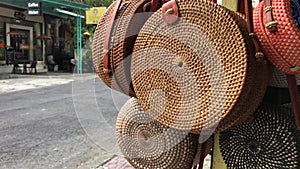 Rattan eco bags in the art shop on Bali island, Indonesia. Woman stylish eco bag.