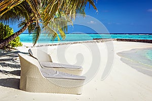 Rattan sun loungers on Maldives beach