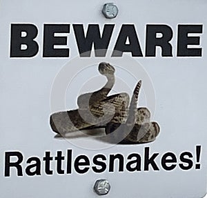 Warning sign for rattle snakes in the Badlands National Park, South Dakota photo