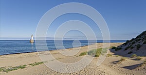 Rattray Point Beach with its Lighthouse just off the Coastline on the East Coast of Scotland