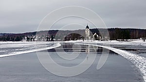 Reflections of Rattvik church in lake Siljan in Dalarna in Sweden photo