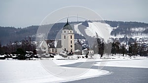 Rattvik kyrka on frozen lake Siljan in Dalarna in Sweden