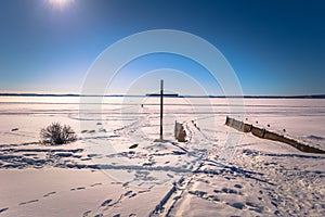 Rattvik - March 30, 2018: Christian cross by the frozen lake Siljan in Rattvik, Dalarna, Sweden photo