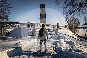Rattvik - March 30, 2018: Traveler by the King Gustav Vasa memorial runestone in Rattvik, Dalarna, Sweden photo