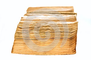 Ratty old book on white background.