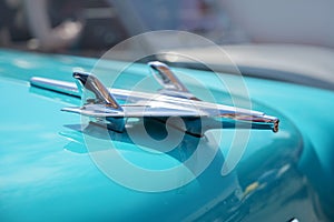 RATZEBURG, GERMANY - JUNE 2, 2019: Plane from chrome, the hood ornament of a Chevrolet automobile, classic Chevy Bel Air from 1956