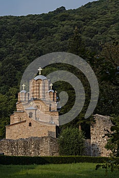 Ravanica monastery Serbia with background of forrested hill photo