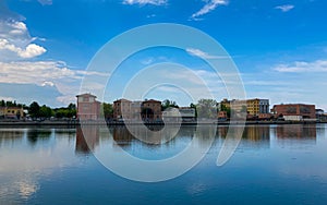 Ravenna, Italy: 10-04-2022: Beautiful buildings reflection on Ravenna`s darsena on a morning sunny day .