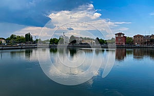 Ravenna, Italy: 10-04-2022: Beautiful buildings reflection on Ravenna`s darsena on a morning sunny day .