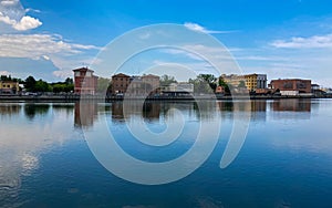 Ravenna, Italy: 10-04-2022: Beautiful buildings reflection on Ravenna`s darsena on a morning sunny day .