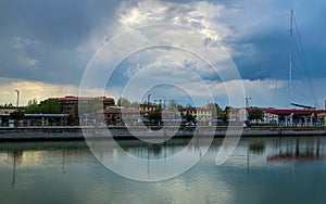 Ravenna, Italy: 10-04-2022: Beautiful buildings reflection on Ravenna`s darsena on a morning sunny day .