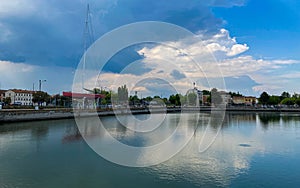 Ravenna, Italy: 10-04-2022: Beautiful buildings reflection on Ravenna`s darsena on a morning sunny day .