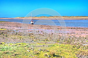 Ravensglass Cumbria near Lake District view of boat and sea colourful hdr