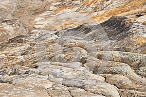 Ravine in a clay land devoid of soil soil at an open pit mining site