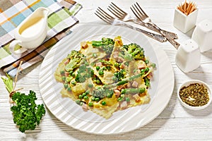 ravioli primavera with ham on a white plate