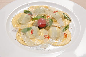 Ravioli with red chily pepper and sweet basil photo