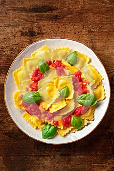 Ravioli with tomato sauce and fresh basil on a plate. Healthy Italian meal