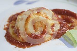 Raviolo at the tomato sauce