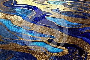 Ravishing blue and golden acrylic liquid ink swirl abstract background.