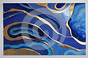 Ravishing blue and golden acrylic liquid ink swirl abstract background.