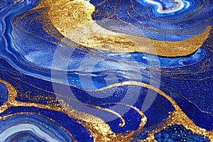 Ravishing blue and golden acrylic liquid ink swirl abstract background.