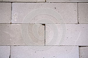 Raw AAC autoclaved aerated concrete wall, front view, background.