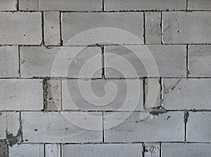 Raw AAC autoclaved aerated concrete wall, front view, background.