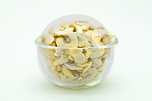 Raw almond on glass bowl, on white