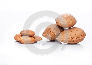 Raw almonds nuts with shell on white background