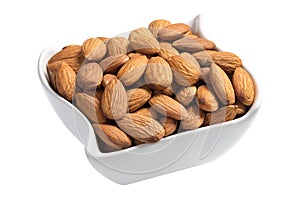 Raw almonds in a white plate isolated on white
