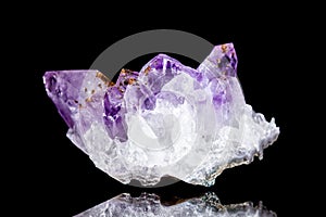 Raw amethyst mineral stone in front of black background