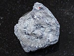 raw antimony ore (Stibnite) stone on dark photo