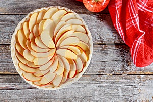 Raw apple pie on wooden table. Ready for baking