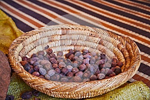 Raw argan nuts in the wooden basket