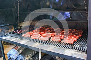 Raw argentine barbecue steaks and blood sausages  on  typical parrilla argentine barbecue photo
