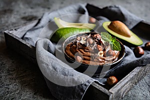 Raw avocado chocolate mousse with hazelnuts