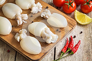 Raw babies cuttlefish on rustic background