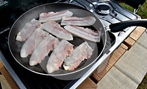 Raw bacon in a skillet
