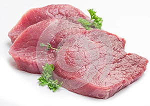 Raw beaf steaks with parsley.