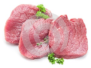 Raw beaf steaks with parsley on a white background.