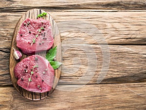 Raw beaf steaks with spices.