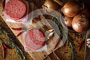 Raw beef burger, traditional barbecue, still life with vegetables and meat