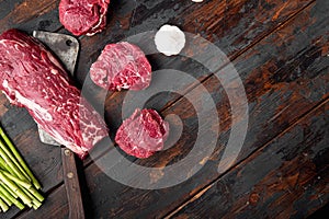 Raw beef filet Mignon steak cut , with old butcher cleaver knife, on old dark  wooden table background, top view flat lay, with