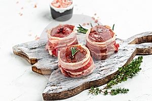 Raw beef filet Mignon steak on metel tray with pepper and salt, filet mignon. beef tenderloin steaks wrapped in bacon and thyme on