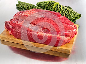 Raw beef flesh on cutting board photo