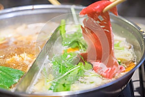 Raw beef getting down boiling in hot pot