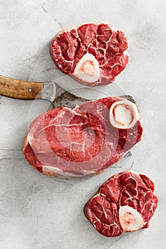 Raw beef meat bone butcher knife top view flat lay