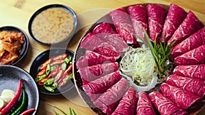 Raw beef meat on a light wooden board.