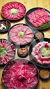 Raw beef meat on a light wooden board.